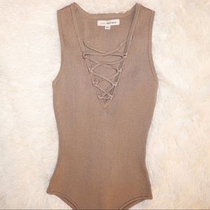 Nude body suit with laced front